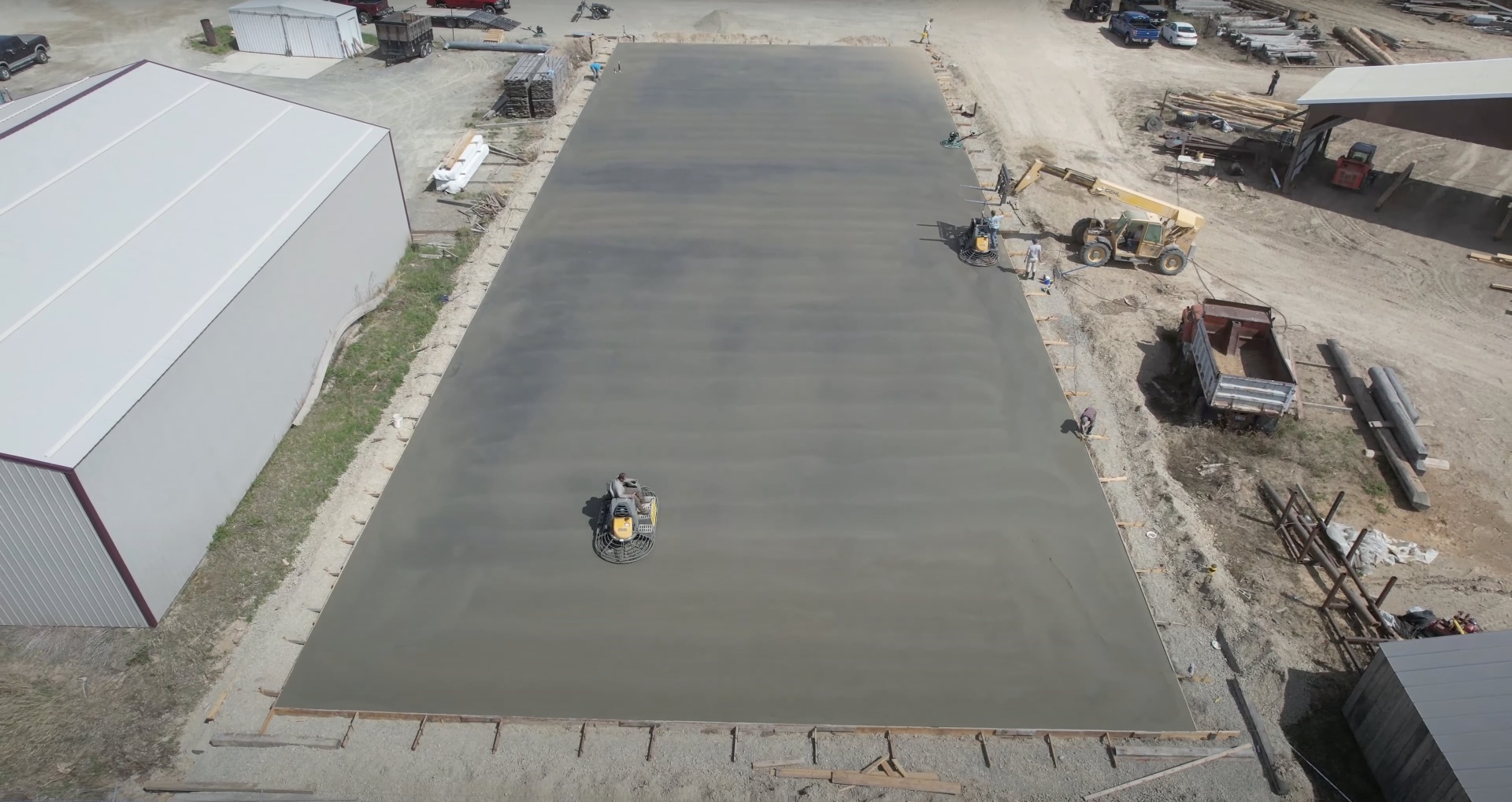 Commercial concrete installation with industrial-grade equipment Large commercial concrete slab pour with professional equipment and crew