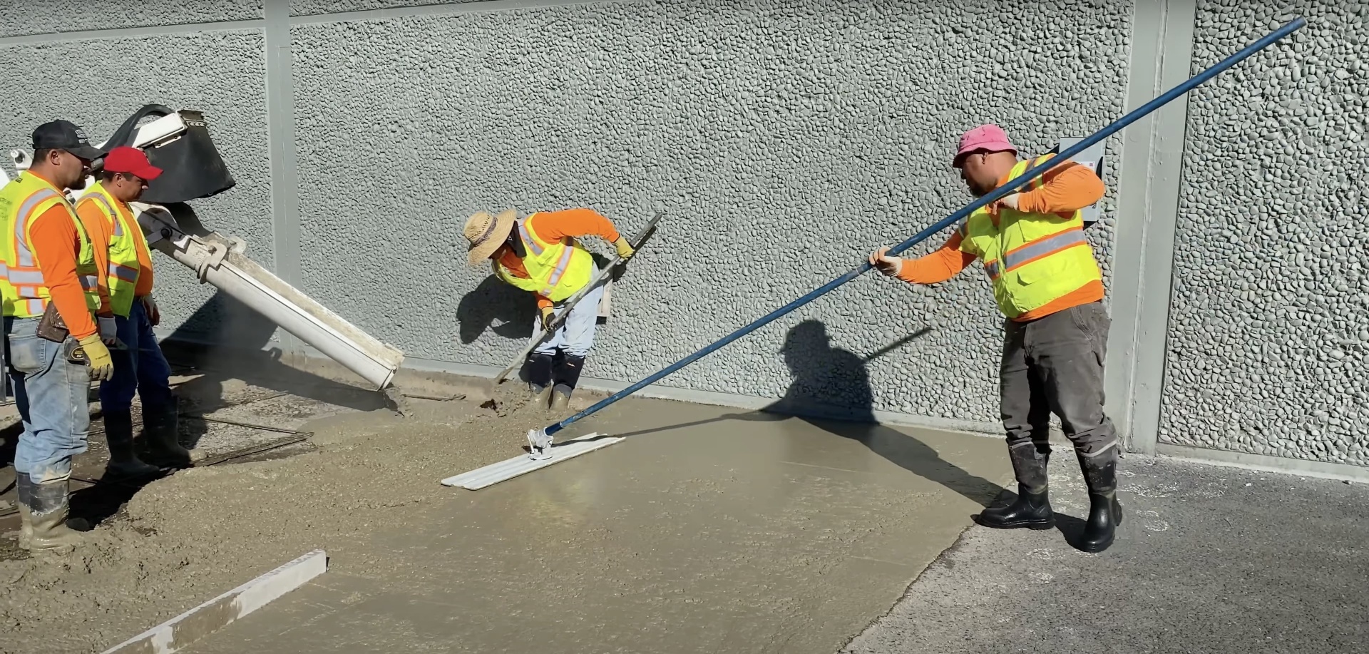 Commercial concrete installation with professional crew and equipment Professional concrete crew using industrial equipment for large pour