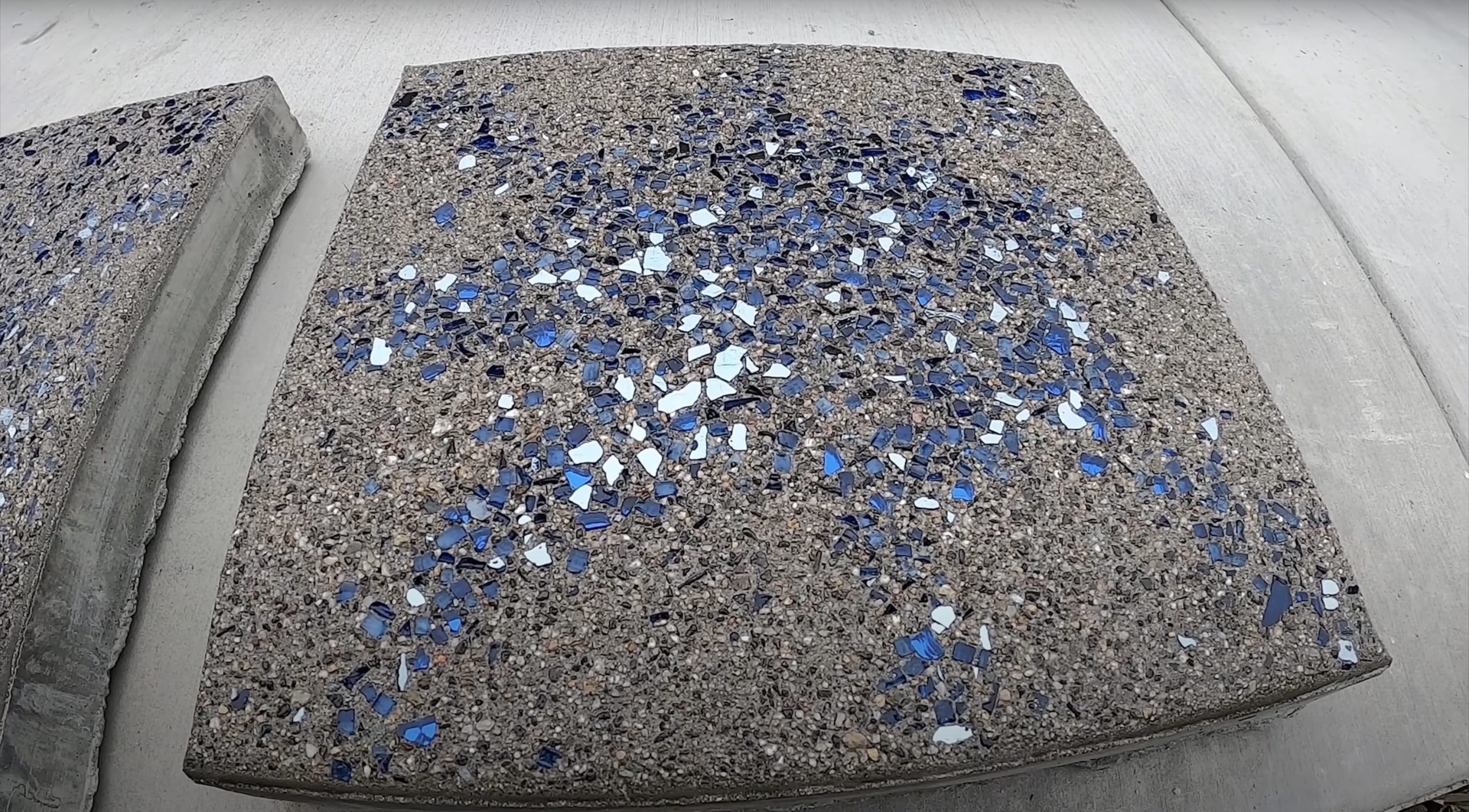 Custom decorative concrete with colored aggregate design Decorative concrete surface with blue and white aggregate finish