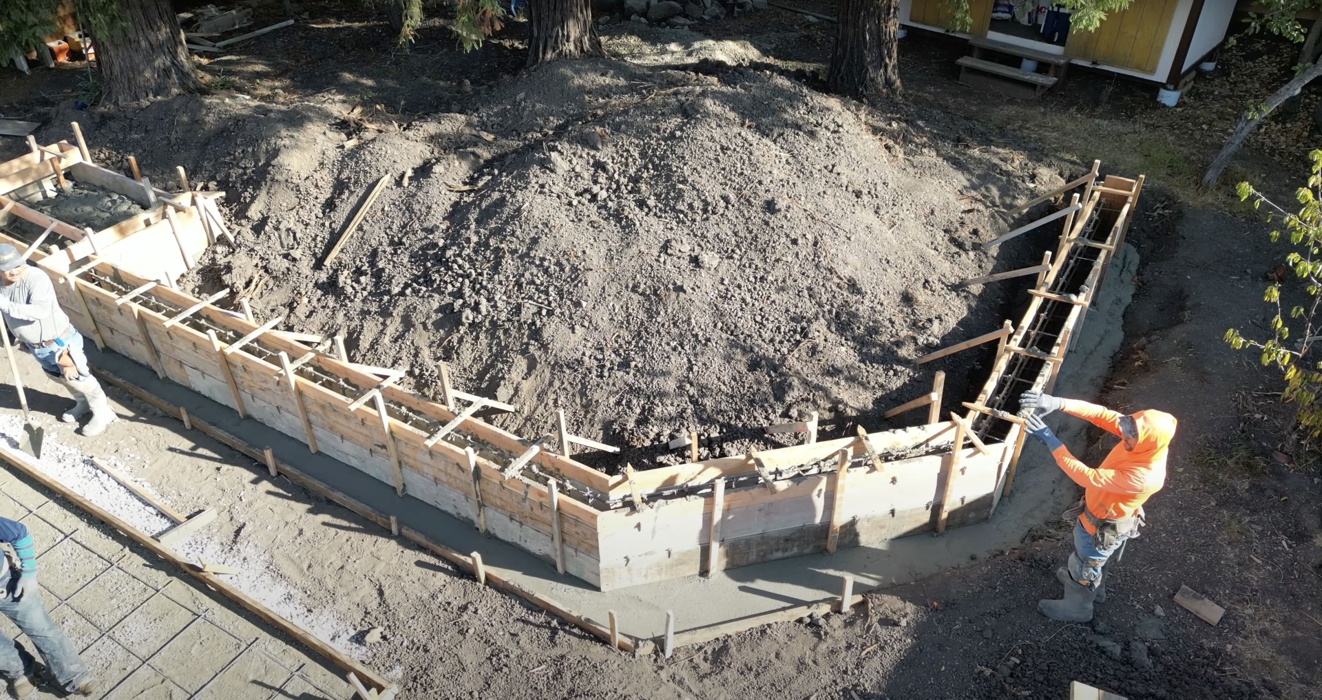 Professional concrete foundation preparation and forming work Construction site preparation with wooden forms for concrete foundation