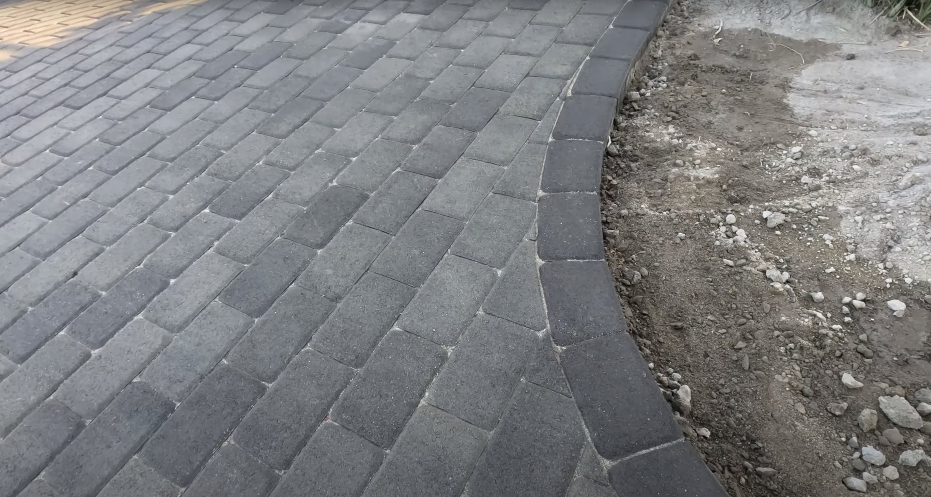 High-quality concrete paver work with detailed pattern layout Professional concrete paver installation with precise herringbone pattern